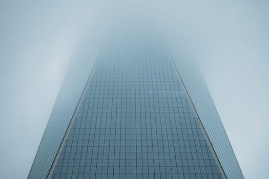 A skyscraper reaches into the clouds, offering a majestic urban ascent.