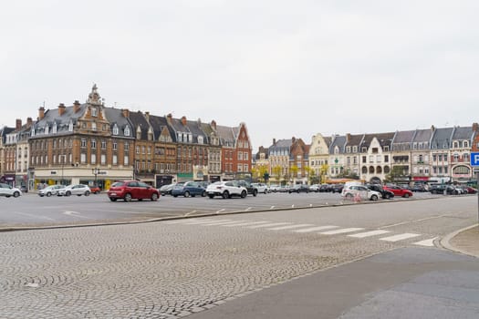 Cambrai, France - May 21, 2023: A city street filled with heavy traffic passing by tall buildings. Cars and buses navigating through the busy urban environment.