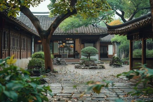 A courtyard with a tree in the center and a small house in the background. The courtyard is surrounded by trees and has a peaceful, serene atmosphere