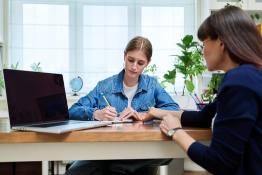 Young teenage girl high school student patient talking with psychologist, therapist, counsellor, social worker. Mental session therapy, support, psychology, psychotherapy, adolescence, youth concept