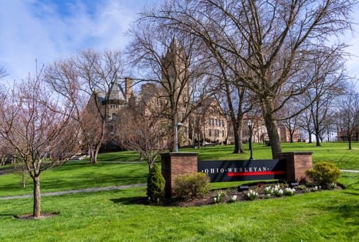 Delaware, Ohio - 8 April 2024: Sign for college by the historic University Hall at Ohio Wesleyan University in Delaware, OH