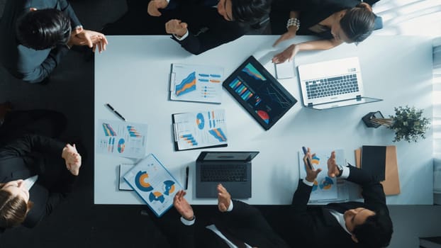 Top down view of professional business team working together to share idea while using colorful sticky note at whiteboard. Diverse project manager choosing or planning marketing strategy. Directorate.