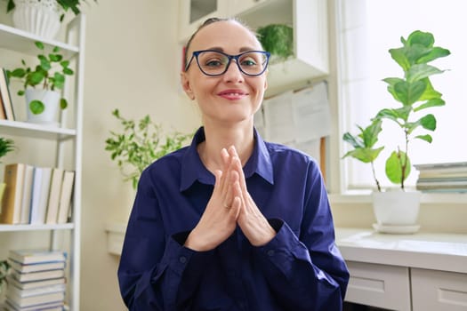 Webcam view of smiling middle-aged woman talking. Female blogger vlogger recording video, business lady during video chat conference call, teacher mentor giving online lesson, filming training course