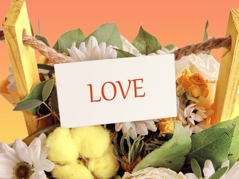 LOVE The concept of relationships and love. text love on a business card enclosed in flowers