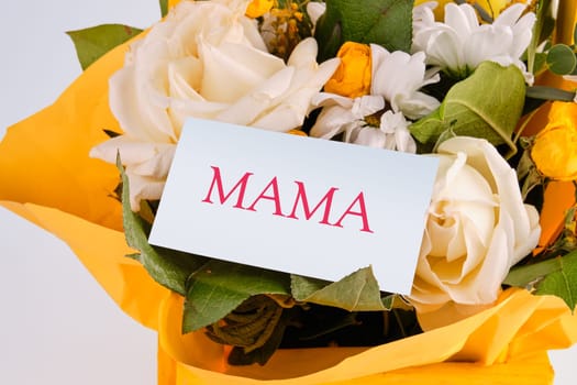 Mama Text on a business card in a bouquet of flowers
