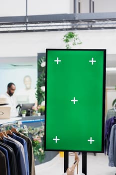 Interactive board with chroma key display for advertisement and shoes showcasing for customers in clothing store. Smart green screen for promotion mock up in shopping mall