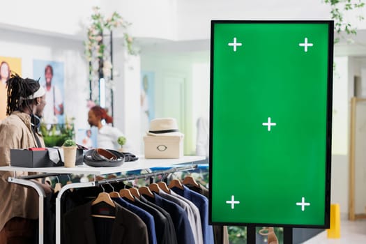 Digital board with green screen for clothes brand promotion mock up in shopping center. Smart display with chroma key for apparel new collection advertisement in fashion boutique