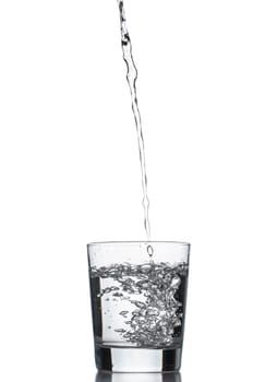 Water poured into glass. Isolated on white background.
