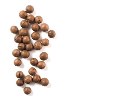 Heap of macadamia nuts on white background with clipping path.. Set of macadamia nuts isolated on white, top view or flat lay. Copy space for text.