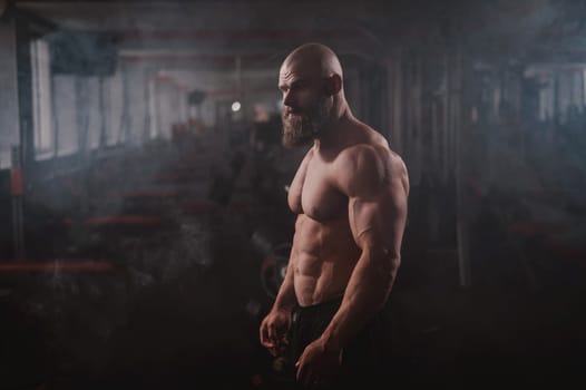 Caucasian bald man posing in the gym