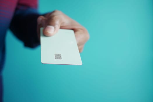 close up of person hand holding credit card.