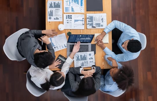 Top view multiracial analyst team use BI dashboard display on laptop screen, analyzing financial data for strategic decision. Fintech analyzes marketing indicators. Concord