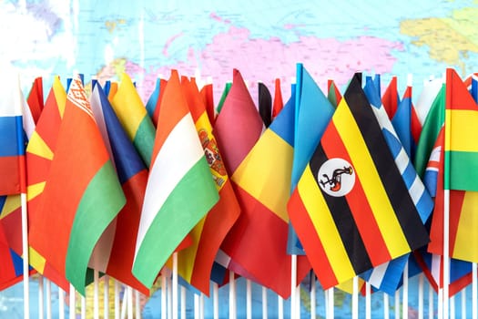 Embracing Diversity: A Tapestry of Nations - Flags of the World Against the Backdrop of World Map.