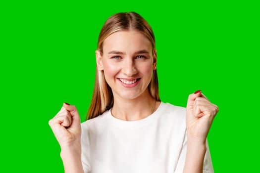 Young Woman Poses for Picture against green background in studio