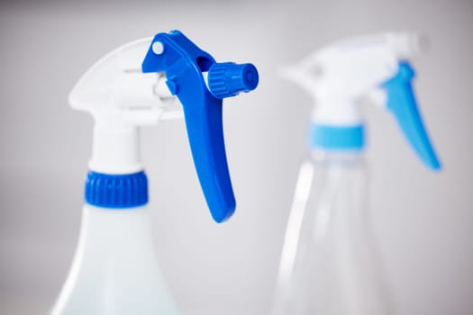 Spray, bottle and product for cleaning closeup in home or detergent in container for janitor service. Chemical, cleaner and tools for washing dirt, dust and protection from bacteria and germs.