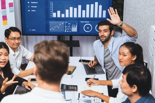 Analyst team utilizing BI Fintech to analyze financial data at table in meeting room. Businesspeople analyzing BI dashboard power for business insight and strategic marketing planning. Prudent