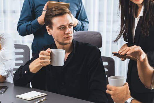 Group of diverse office worker employee drinking coffee while working together on strategic business marketing planning in corporate office room. Positive teamwork in business workplace. Prudent