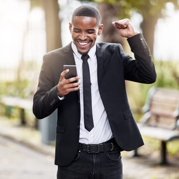 Business, celebration and black man with phone outdoor at park for goal, success or winning prize. Mobile, yes and cheers of excited professional salesman reading good news, bonus or career promotion.