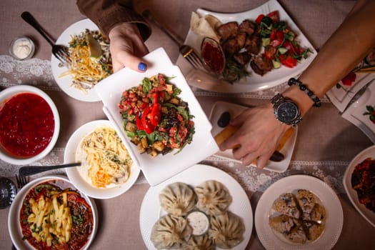 A table with delicious Uzbek dishes like soup, salad, dumplings, and meat skewers, offering a taste of Uzbekistans culinary heritage