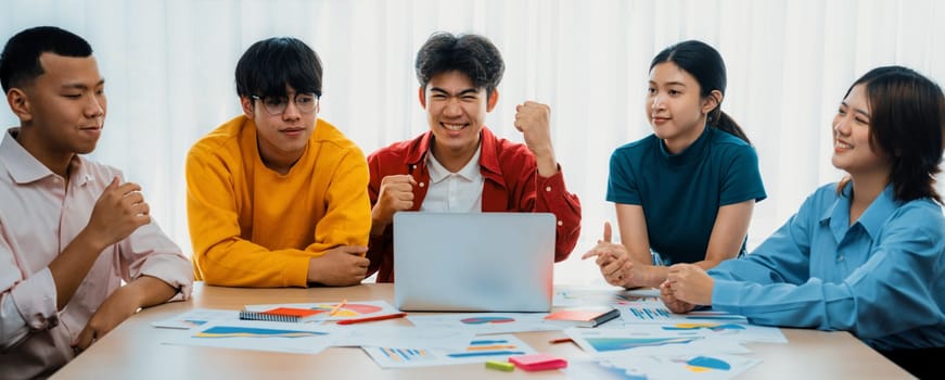 Excited and happy startup company employee celebrate after make successful strategic business marketing planning. Teamwork and positive attitude create productive and supportive workplace. Synergic