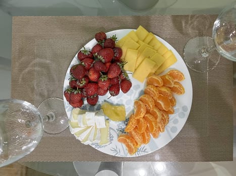 A beautiful still life of a place setting with fruit and wine. Perfect for a romantic dinner or a relaxing evening at home.