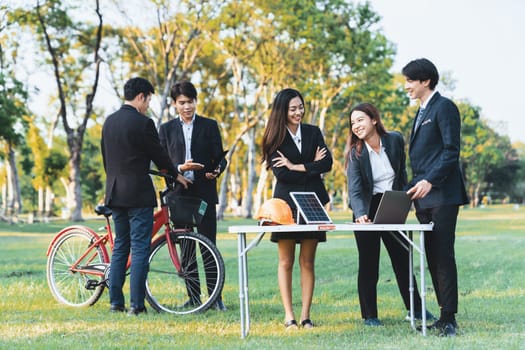 Group of asian business people with strong teamwork establish outdoor eco business office at natural park develop environmentally friendly and sustainable technology project for greener future. Gyre