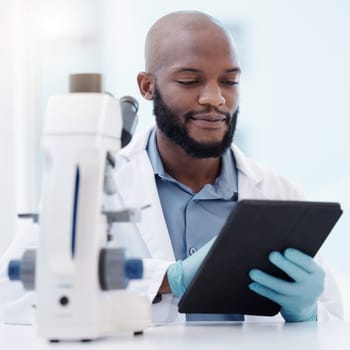 Black man, scientist and tablet in laboratory for research, innovation or healthcare with gloves for hygiene. Male person, studying or planning in lab for medical diagnosis, test or experiment.