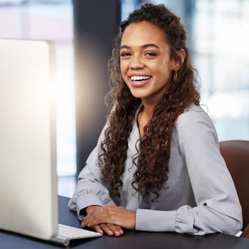 Portrait, smile and business woman in office by computer for career, job or working at startup company. Face, happy professional and entrepreneur, creative employee and copywriter laughing in Dubai.