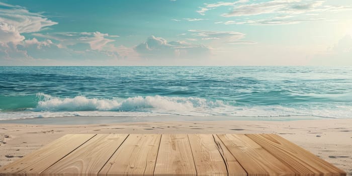 A wooden board is on the beach next to the ocean. The ocean is calm and the sky is blue