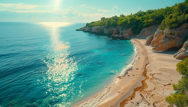 A beautiful beach with a clear blue ocean and a rocky shore. The sun is shining on the water, creating a sparkling effect. The beach is empty, with no people visible. The scene is peaceful and serene