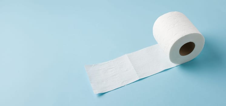 Top view of toilet paper roll on blue background