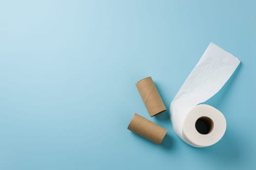 Top view of toilet paper roll on blue background