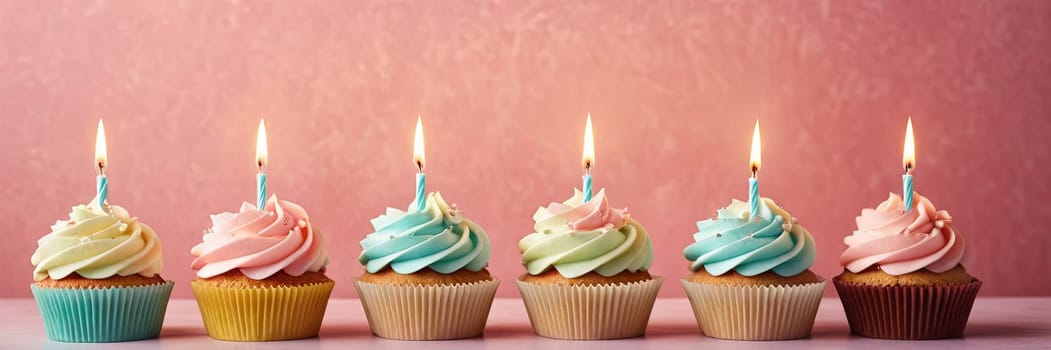 Colorful cupcakes with lit candles are displayed against a pink background, indicating an indoor celebration event marking of joy and celebrating. banner with free space.