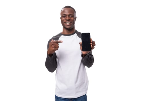 young smart charismatic american man has news and points finger at smartphone with mockup.