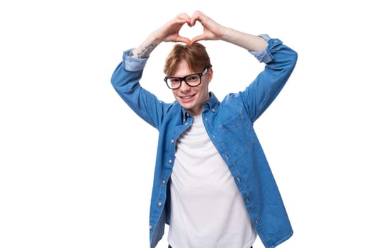 young kind cute european man with copper hair wears denim shirt and white t-shirt.