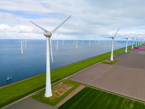 A mesmerizing view of a row of sleek white wind turbines in full motion, set against the vibrant green landscapes of the Netherlands in Spring. windmill turbines at sea and on land