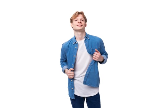 young well-groomed caucasian red-haired man in a denim shirt looks stylish.