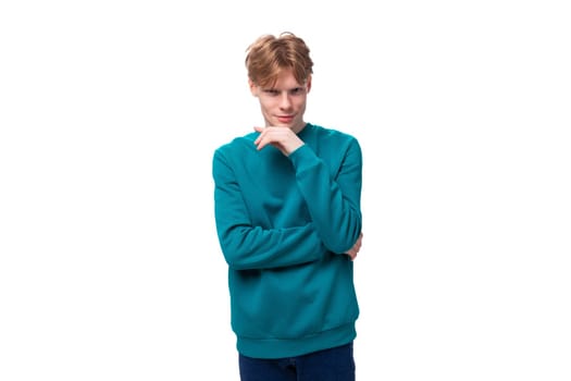 young authentic handsome man with red hair wearing a blue sweater.