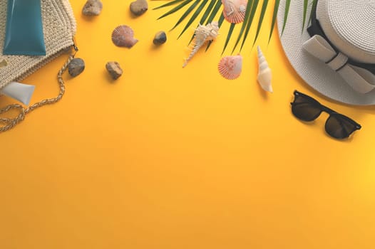 Traveler accessories and seashells on yellow background. Summer and travel vacation concept.