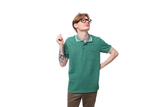 young dreaming european guy with red hair in glasses raised his head up and thinks.