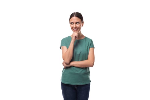 young charismatic black-haired woman with collected hair is dressed in a basic t-shirt and jeans.