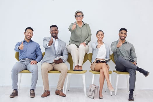 Mature woman, group and thumbs up for recruitment, selection or job opportunity with technology and notebook. Diversity, people and candidates in business, corporate or hiring for employment contract.