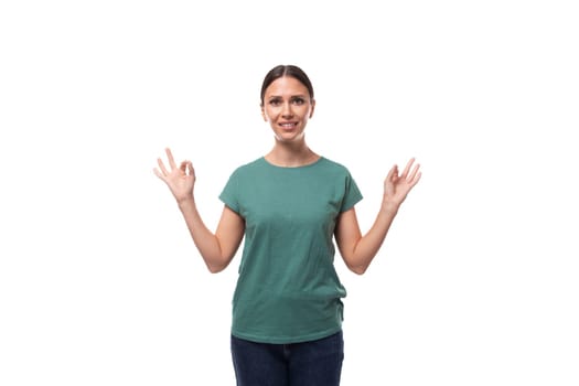 young slim woman dressed in a green basic t-shirt with branding print space.