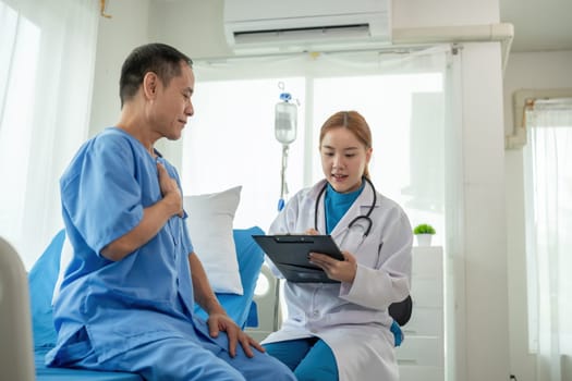 A female doctor is examining the body and taking notes on a sick person in a hospital examination room..