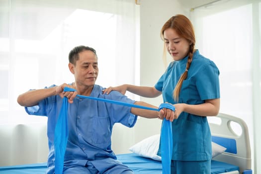 A sick caregiver or young nurse is helping a patient who is rehabilitating with physical therapy at the hospital..