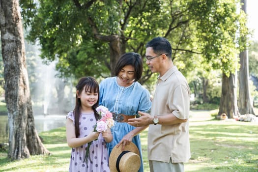 warm family There are parents and children doing picnic activities and relaxing outside together at the park on holidays..