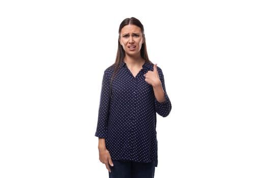 young confident smart brunette woman dressed in a blue blouse with a pattern of peas on a white clean background.