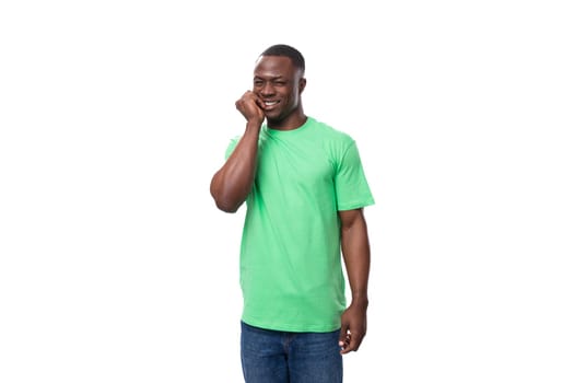 young handsome african man in light green t-shirt and jeans is worried.
