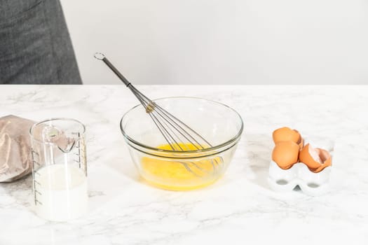 In the process of creating mouthwatering chocolate cupcakes, the first step involves meticulously mixing the ingredients in a glass mixing bowl to make the perfect batter.