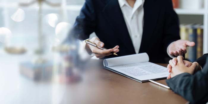 lawyer advises his client about documents. A lawyer explains the law to his client.